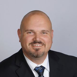 a bald man in a suit