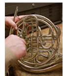 a hand holding a coiled rope